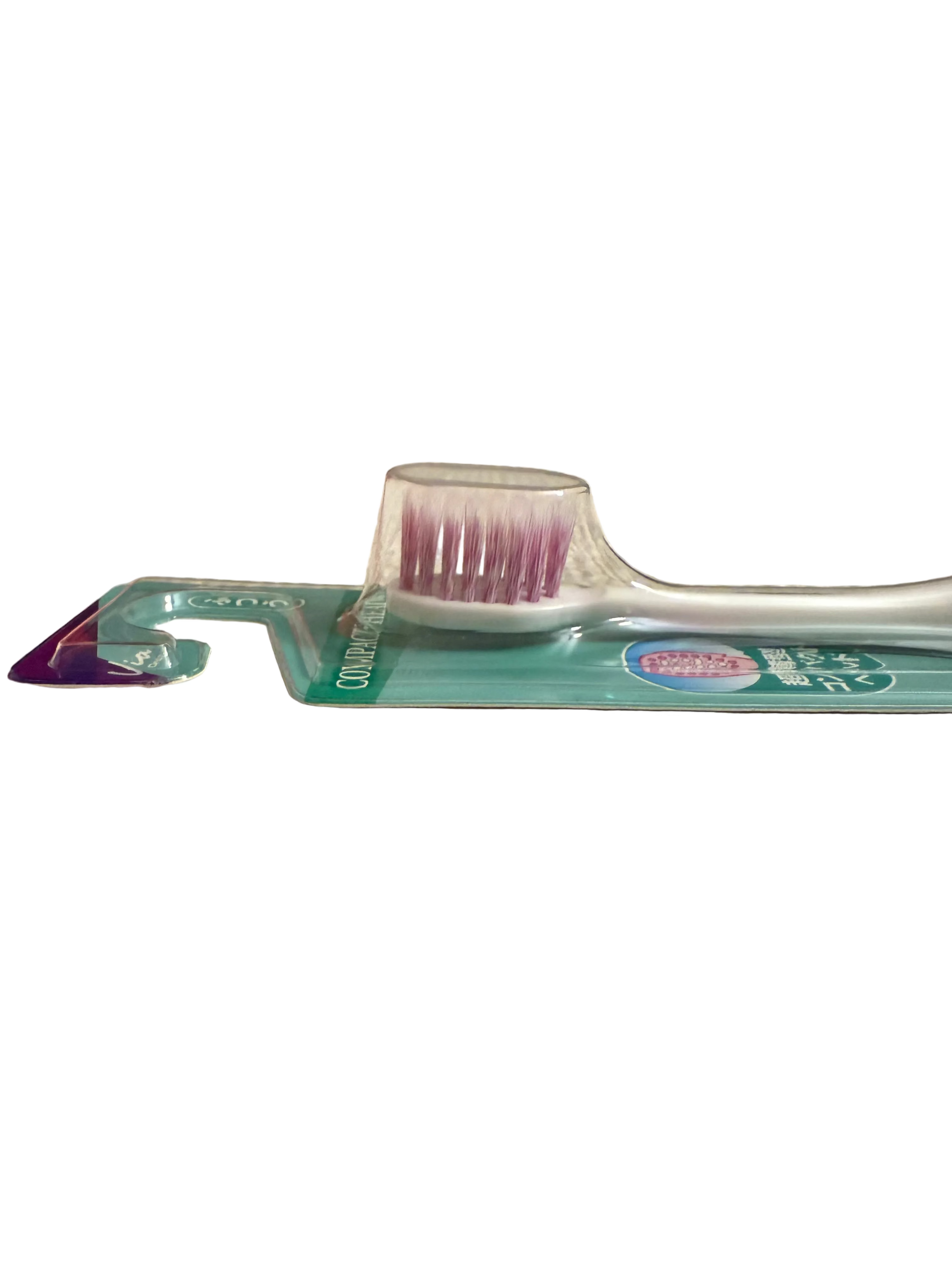 Toothbrush bristles with packaging on a white surface.