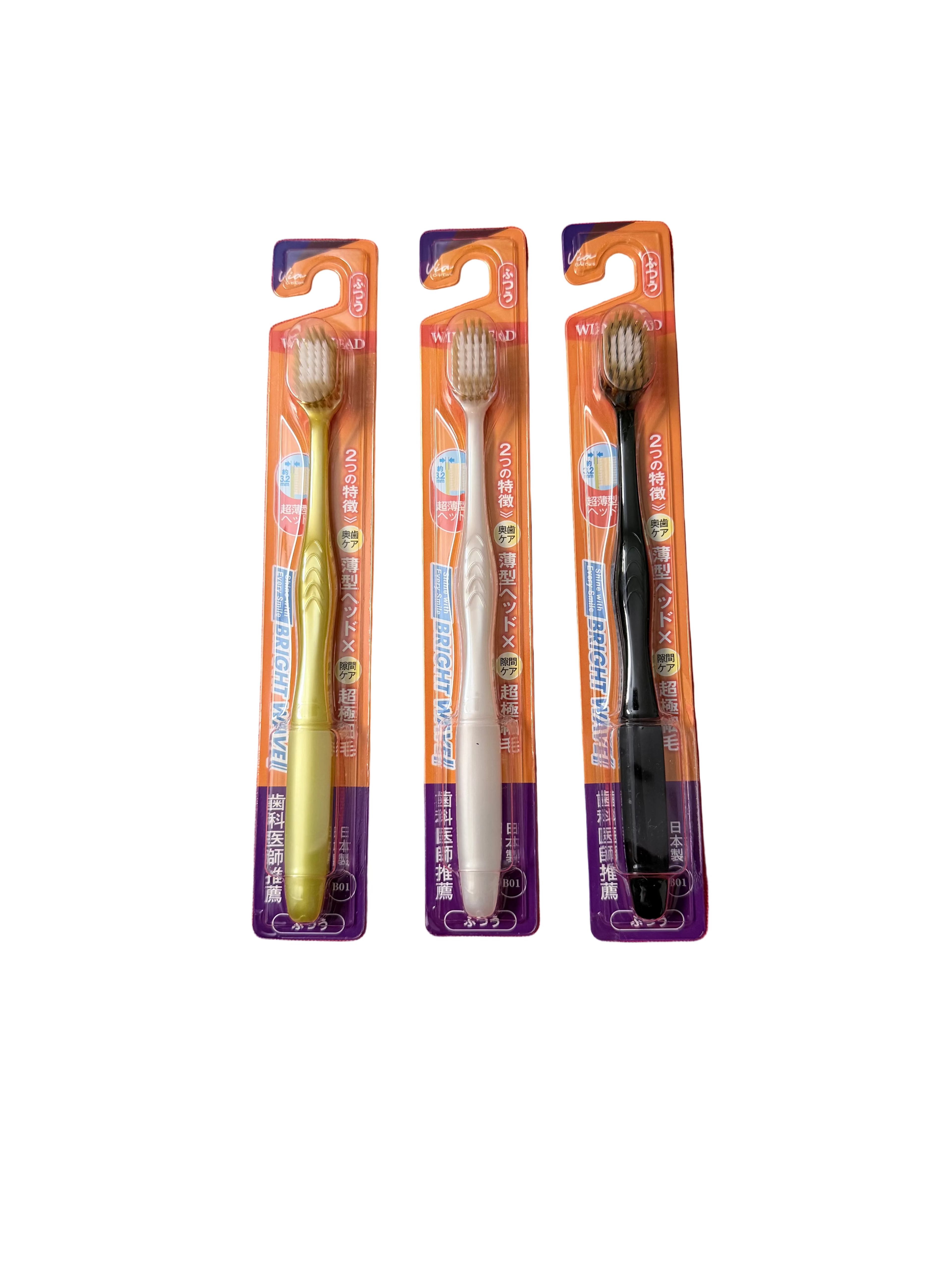 Three toothbrushes on a white surface