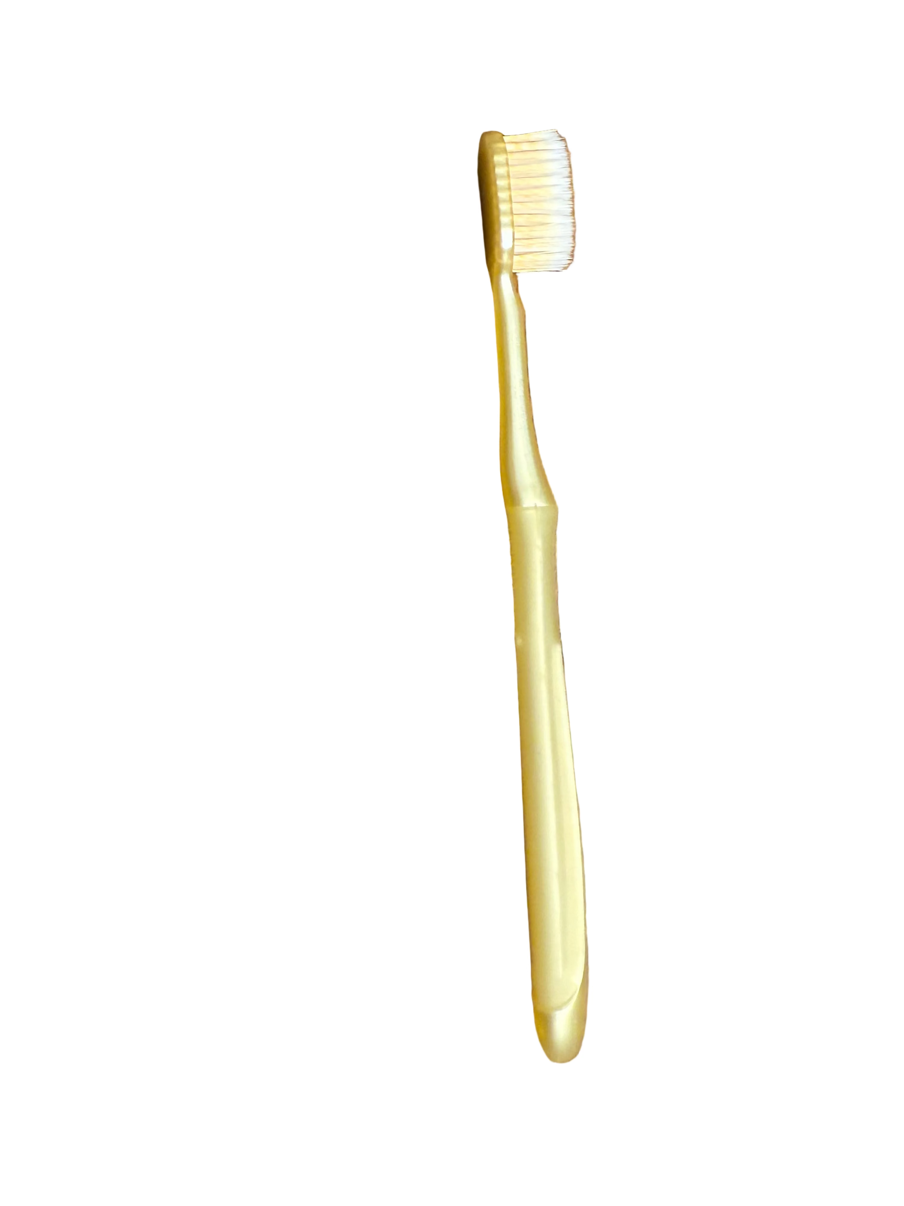 Gold toothbrush side on a white surface
